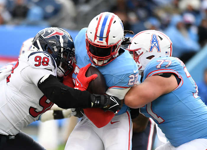 Titans running back Derrick Henry is tackled by Houston Texans defensive tackle Sheldon Rankins (98) during the second half at Nissan Stadium.